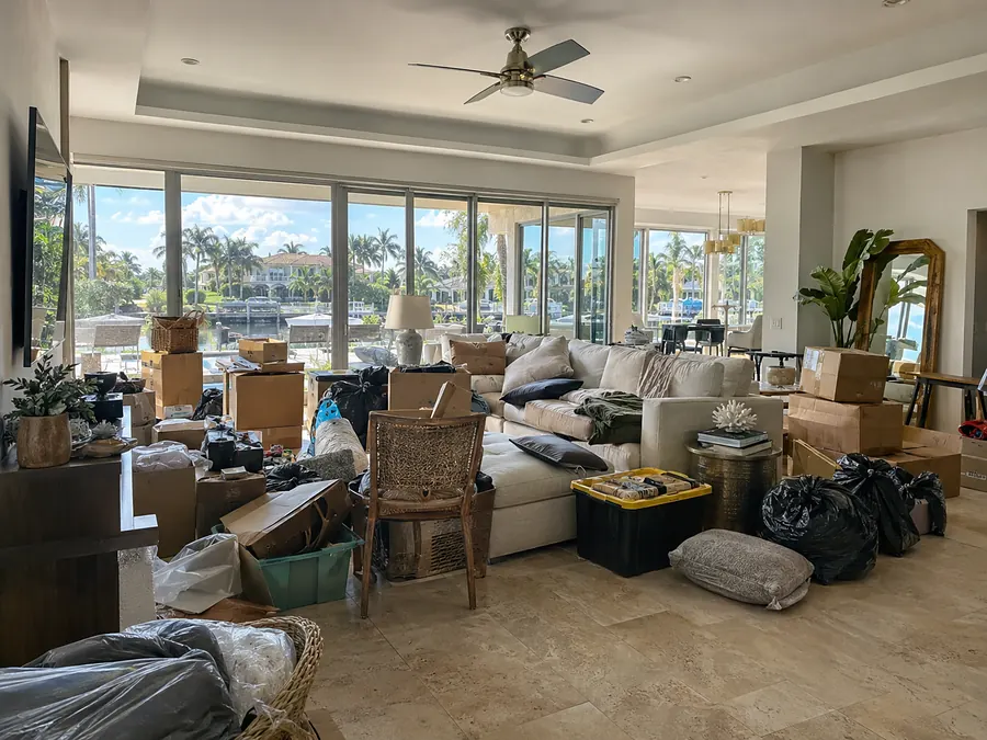 A living room packed with boxes and clutter